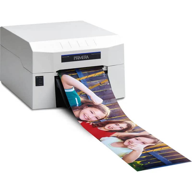 A Primera printer outputting a photo strip of three smiling individuals, showcasing R & R Pose’s on-site printing service at events.